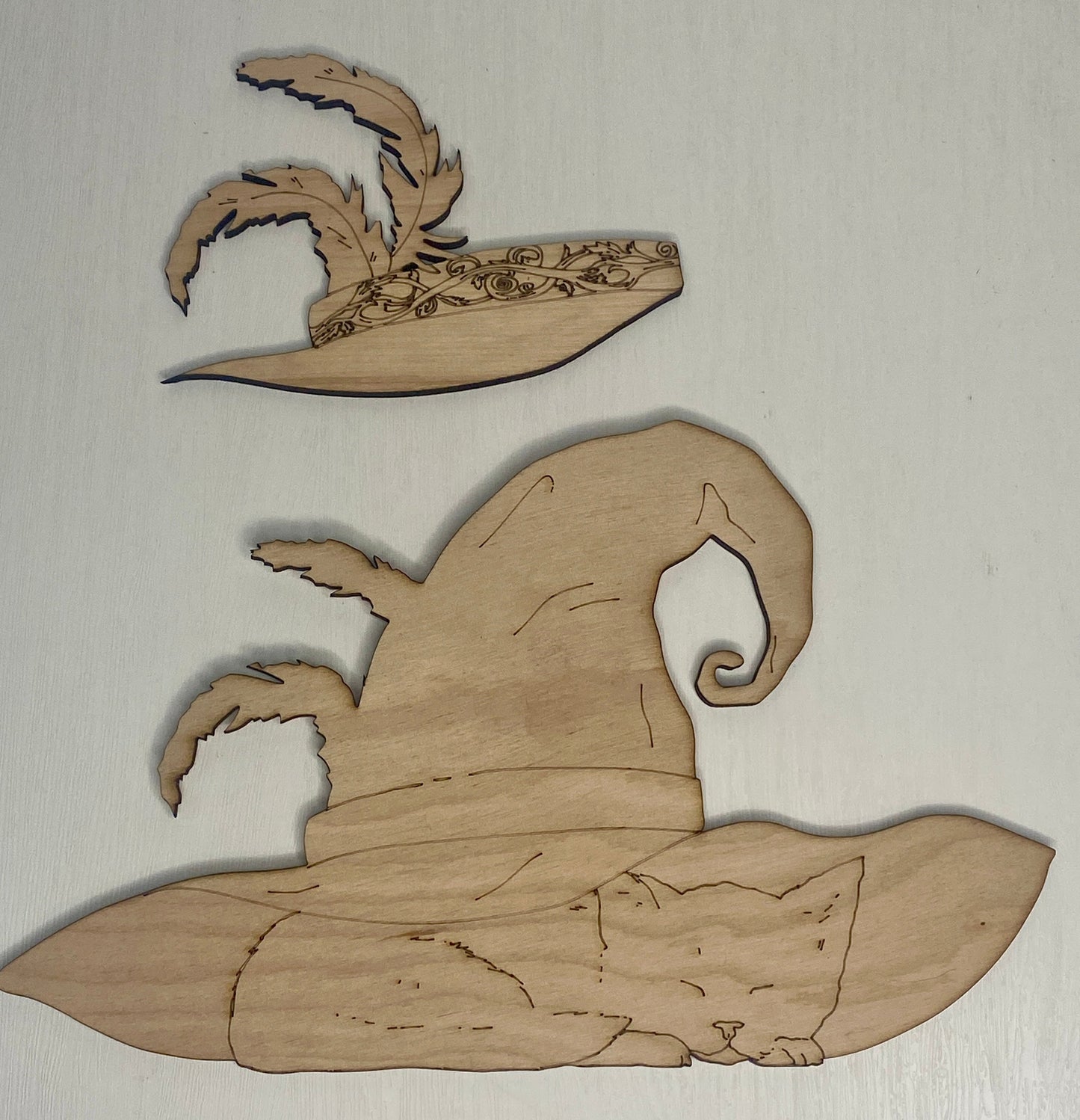 Wooden cutout of a witch's hat with a cat inside 